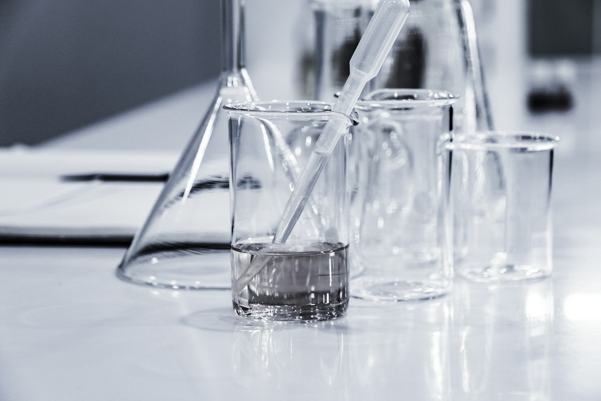 Researcher in biosafety lab with test tubes