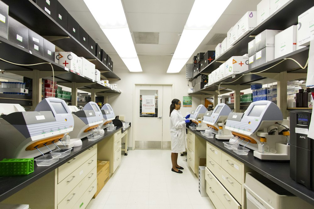Scientist looking through microscope in safety lab